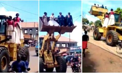Unique scenes as a newlywed couple and their bridesmaids are ferried in a loader