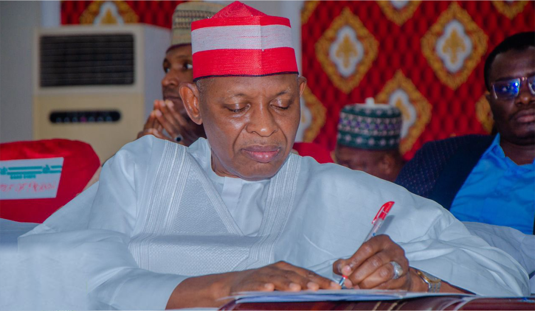 Governor Abba Yusuf signing a doument