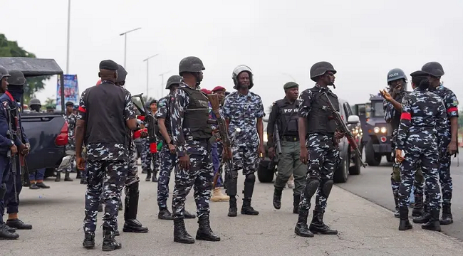 Members of the Nigerian Police Force stand guard