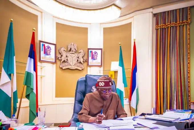 Tinubu writes signs.jpg 1