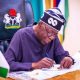 Tinubu signs writes 2